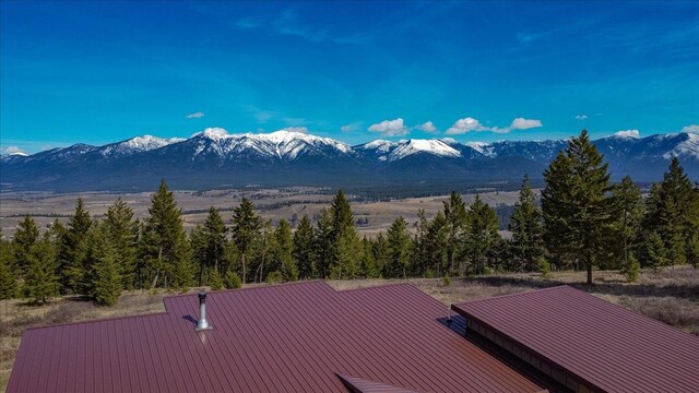 563 Riding High Dr, Eureka, MT 59917 - view from above of property with a heavily wooded area and a mountainous background