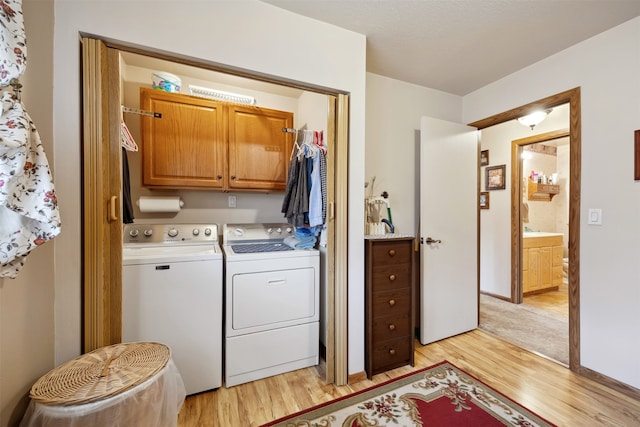 2804 Harmony Ct, Missoula, MT 59801 - washroom featuring cabinet space, separate washer and dryer, and light wood-style floors