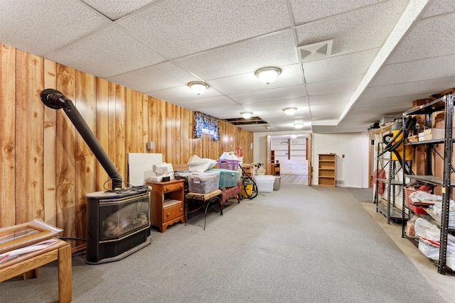 2804 Harmony Ct, Missoula, MT 59801 - finished below grade area with a wood stove, wood walls, a paneled ceiling, and carpet floors