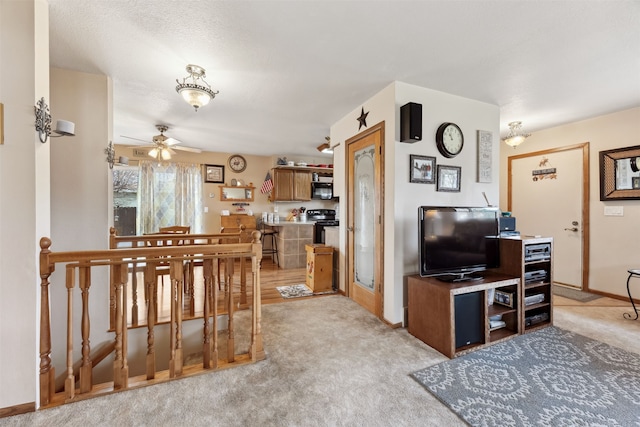 2804 Harmony Ct, Missoula, MT 59801 - living area with ceiling fan, light colored carpet, and baseboards
