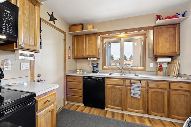 2804 Harmony Ct, Missoula, MT 59801 - kitchen with black appliances, a sink, light countertops, brown cabinets, and light wood-type flooring