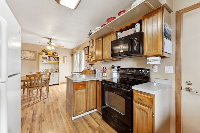 2804 Harmony Ct, Missoula, MT 59801 - kitchen featuring black appliances, a peninsula, light countertops, light wood-type flooring, and brown cabinets