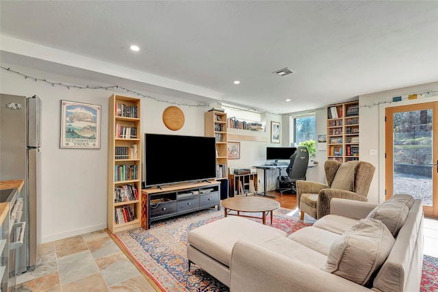living room featuring visible vents, baseboards, and recessed lighting