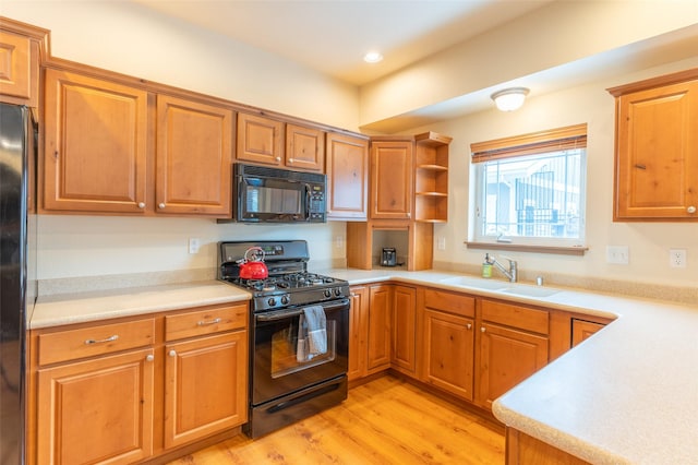 402 Sperry Ct, Whitefish, MT 59937 - kitchen with black appliances, light wood-type flooring, light countertops, brown cabinets, and recessed lighting