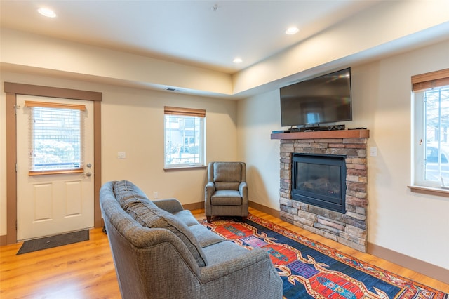 402 Sperry Ct, Whitefish, MT 59937 - living room with wood finished floors, a stone fireplace, and recessed lighting
