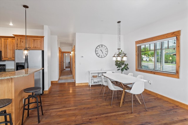 dining room featuring baseboards and dark wood-style floors
