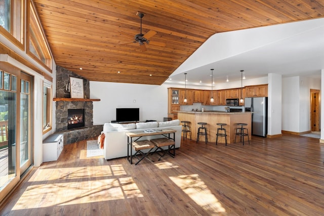living room featuring wooden ceiling, ceiling fan, a fireplace, and dark wood-type flooring