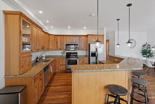 150 Adams St Unit 5, Lakeside, MT 59922 - kitchen with stainless steel appliances, dark wood-style flooring, a kitchen breakfast bar, glass insert cabinets, and recessed lighting