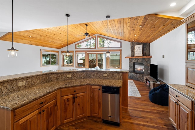 150 Adams St Unit 5, Lakeside, MT 59922 - kitchen featuring vaulted ceiling, dark wood-type flooring, a stone fireplace, open floor plan, and brown cabinets