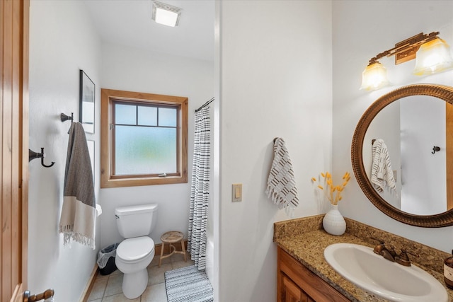 bathroom featuring vanity, baseboards, tile patterned flooring, and toilet