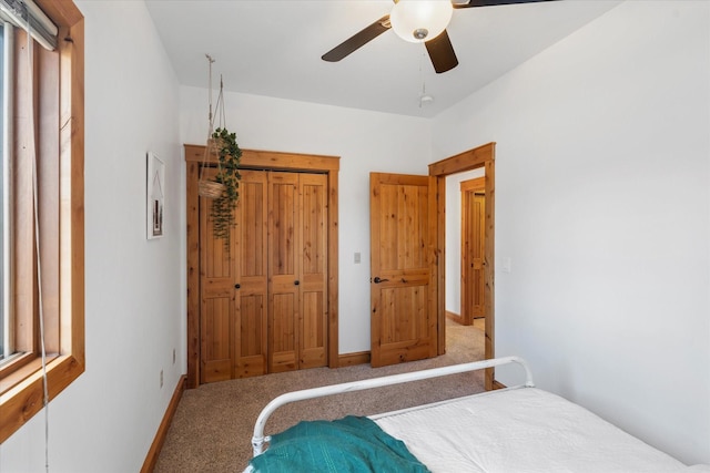 carpeted bedroom with baseboards and ceiling fan