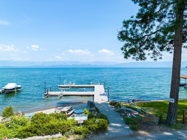 view of dock featuring a water and mountain view