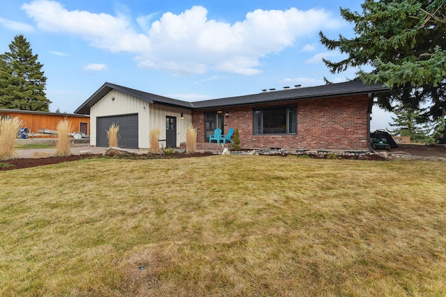 view of front of home with a front lawn, a garage, and brick siding