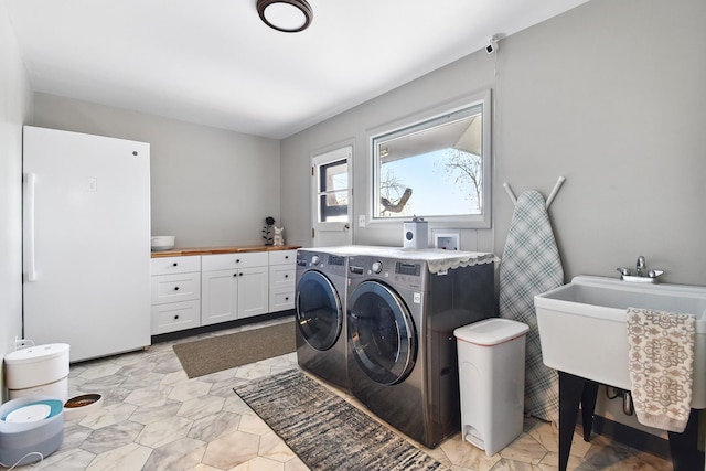laundry room featuring cabinet space and washing machine and dryer