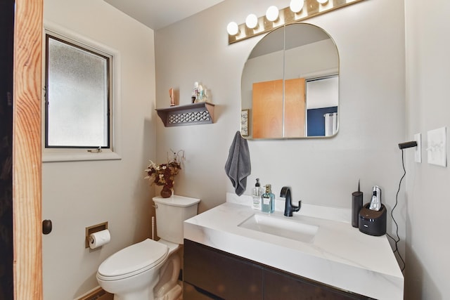 bathroom featuring toilet and vanity