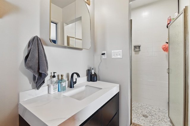 full bath featuring vanity and a shower stall