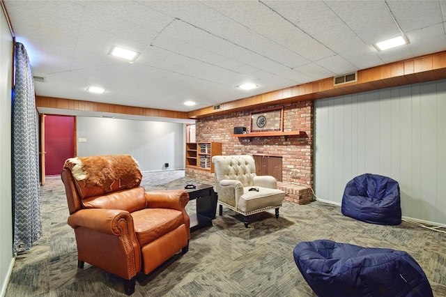 living area featuring visible vents, carpet, and a brick fireplace