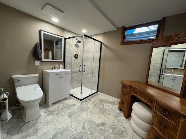 bathroom with baseboards, a sink, a stall shower, and toilet