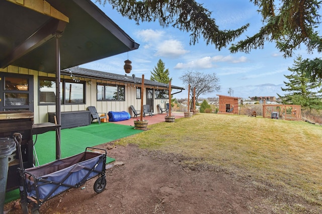 view of yard with an outdoor structure and a patio area
