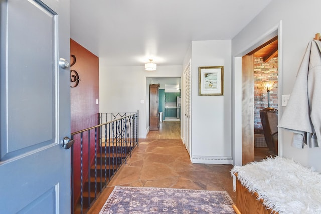 corridor featuring baseboards and an upstairs landing