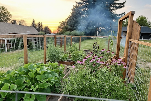 yard at dusk with fence and a garden