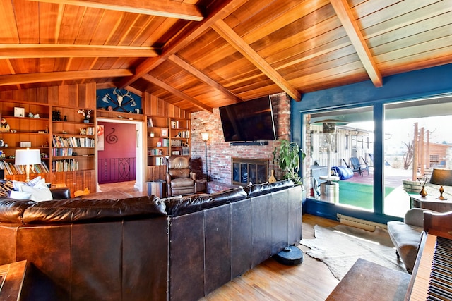 living area featuring a fireplace, wood finished floors, built in shelves, vaulted ceiling with beams, and wood ceiling