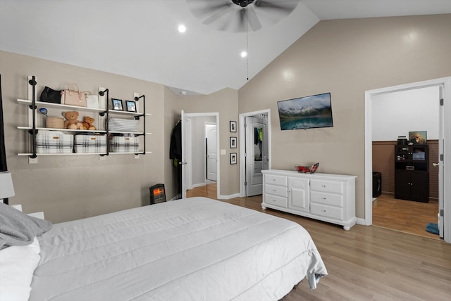 bedroom featuring baseboards, ceiling fan, wood finished floors, and high vaulted ceiling