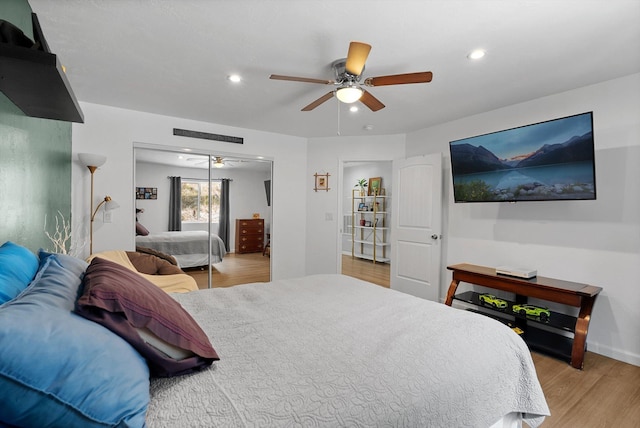 bedroom with light wood-style floors, recessed lighting, ceiling fan, and a closet