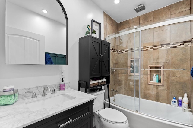 bathroom featuring vanity, recessed lighting, combined bath / shower with glass door, and toilet