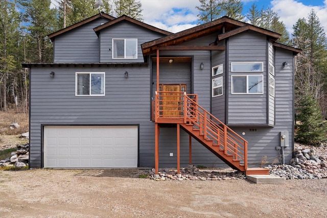 view of front of house with a garage, stairs, and driveway