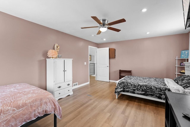 bedroom with ceiling fan, visible vents, baseboards, light wood-style floors, and recessed lighting