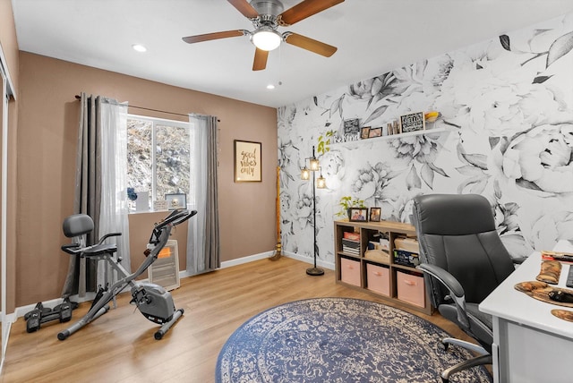 office space featuring light wood-style flooring, an accent wall, a ceiling fan, baseboards, and recessed lighting
