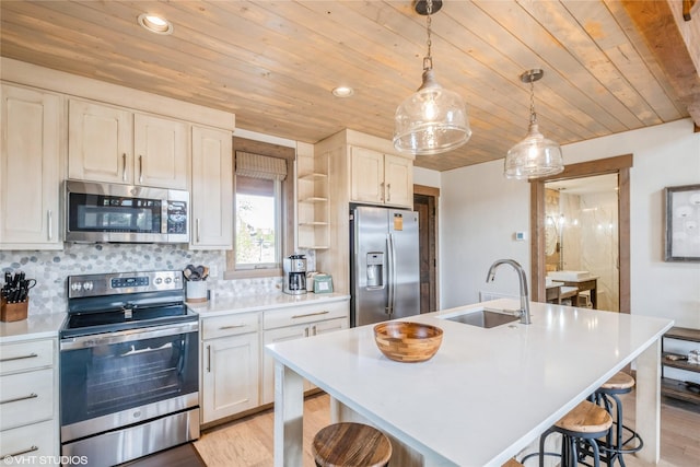 15 Haflinger Cottage Way, Eureka, MT 59917 - kitchen featuring stainless steel appliances, a sink, wooden ceiling, light countertops, and a kitchen breakfast bar