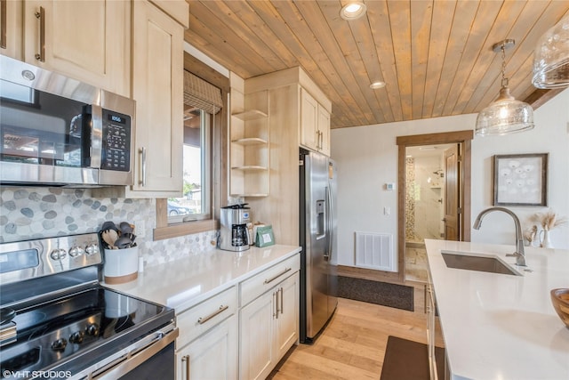 15 Haflinger Cottage Way, Eureka, MT 59917 - kitchen with stainless steel appliances, a sink, light countertops, wooden ceiling, and light wood-style flooring