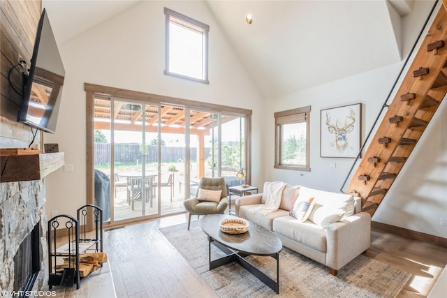 15 Haflinger Cottage Way, Eureka, MT 59917 - living area with high vaulted ceiling, healthy amount of natural light, wood finished floors, a fireplace, and baseboards