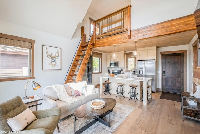 15 Haflinger Cottage Way, Eureka, MT 59917 - living room with stairway, light wood-style floors, and a high ceiling