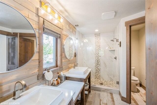 15 Haflinger Cottage Way, Eureka, MT 59917 - full bathroom with a marble finish shower, toilet, double vanity, and wood finished floors