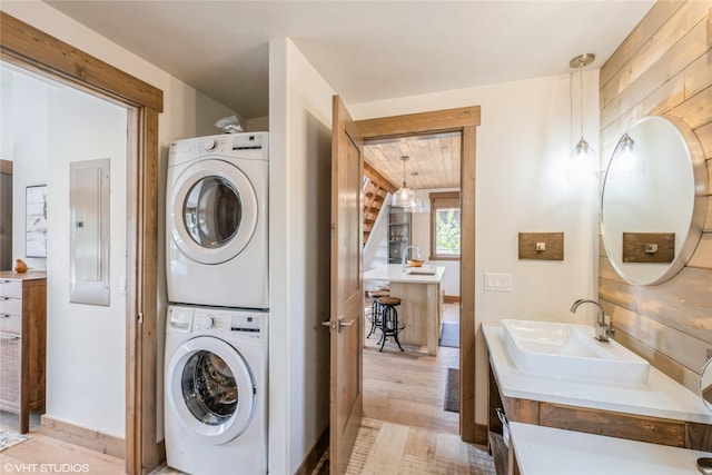 15 Haflinger Cottage Way, Eureka, MT 59917 - washroom featuring estacked washer and dryer, electric panel, and light wood-style flooring
