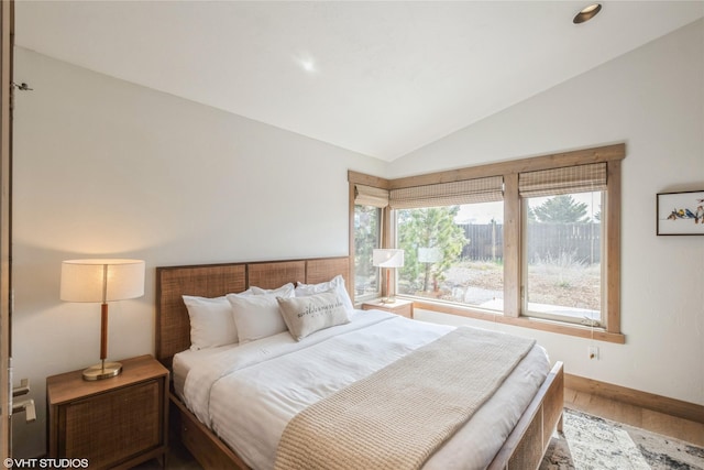 15 Haflinger Cottage Way, Eureka, MT 59917 - bedroom featuring vaulted ceiling, baseboards, and wood finished floors