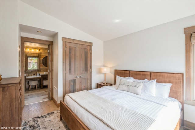 15 Haflinger Cottage Way, Eureka, MT 59917 - bedroom featuring vaulted ceiling, light wood-style flooring, and a closet
