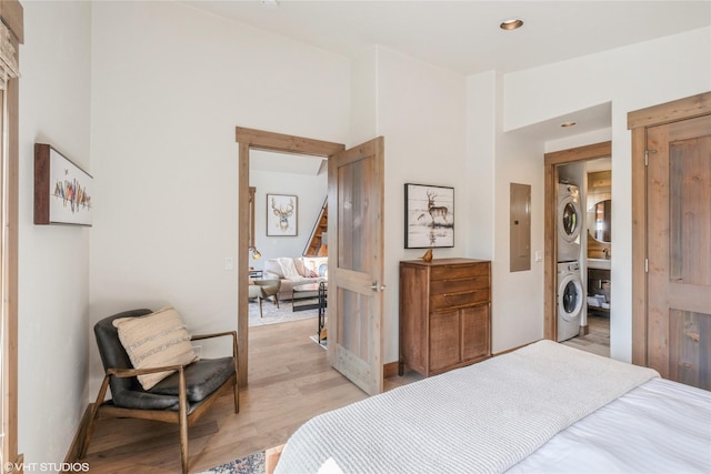 15 Haflinger Cottage Way, Eureka, MT 59917 - bedroom with stacked washing machine and dryer, light wood finished floors, and electric panel