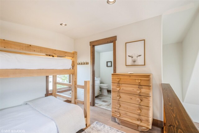 15 Haflinger Cottage Way, Eureka, MT 59917 - bedroom featuring wood finished floors, recessed lighting, baseboards, and connected bathroom