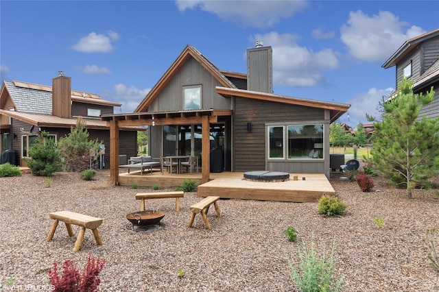 15 Haflinger Cottage Way, Eureka, MT 59917 - back of property featuring a chimney and a wooden deck
