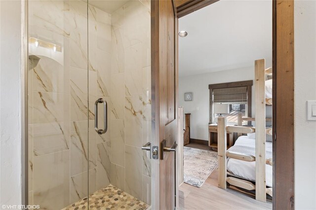 15 Haflinger Cottage Way, Eureka, MT 59917 - ensuite bathroom featuring a marble finish shower and wood finished floors