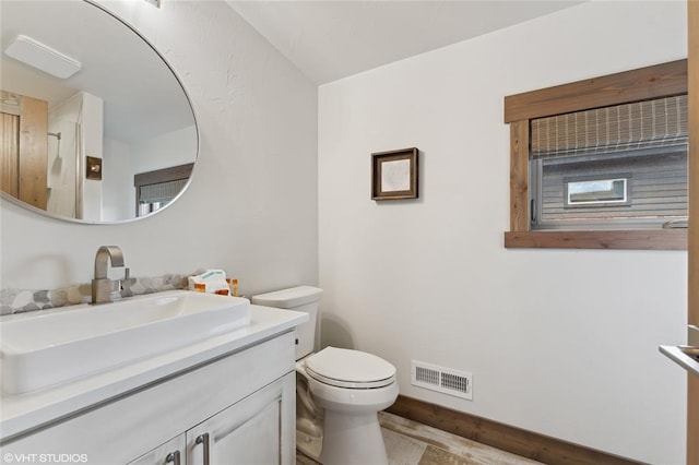 15 Haflinger Cottage Way, Eureka, MT 59917 - bathroom with vanity, toilet, and baseboards