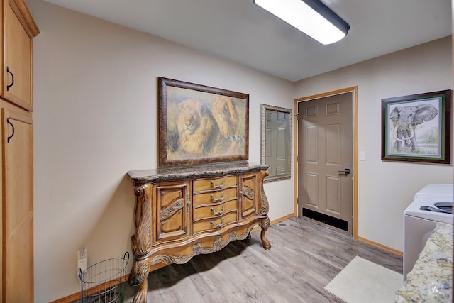 interior space featuring light wood-style flooring and baseboards