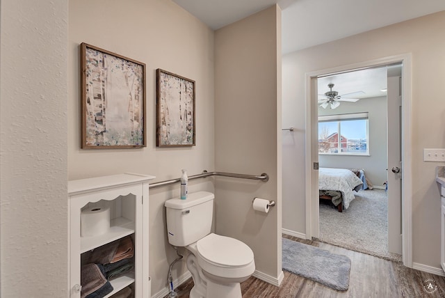 ensuite bathroom featuring baseboards, a ceiling fan, connected bathroom, toilet, and wood finished floors