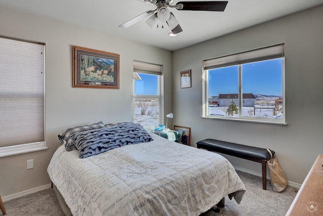 carpeted bedroom with baseboards and ceiling fan