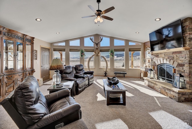living area with ceiling fan, a stone fireplace, recessed lighting, carpet floors, and lofted ceiling