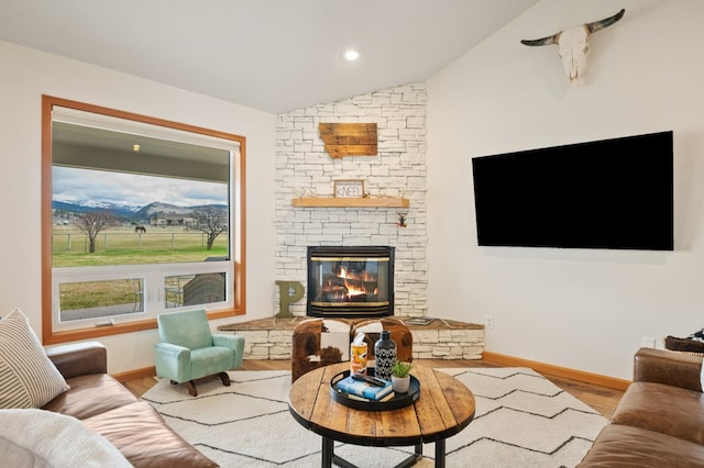5632 Fairview Ln, Florence, MT 59833 - living area featuring baseboards, wood finished floors, recessed lighting, a stone fireplace, and vaulted ceiling